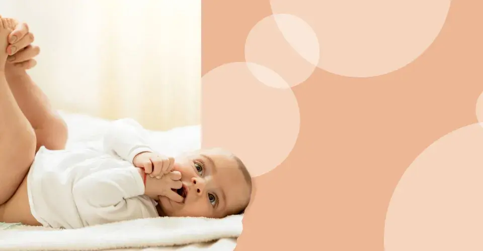 Delikatna pielęgnacja niemowlaka, która zapobiega odparzeniom odbytu. Mama zmienia pieluszkę, maluch leży na plecach.