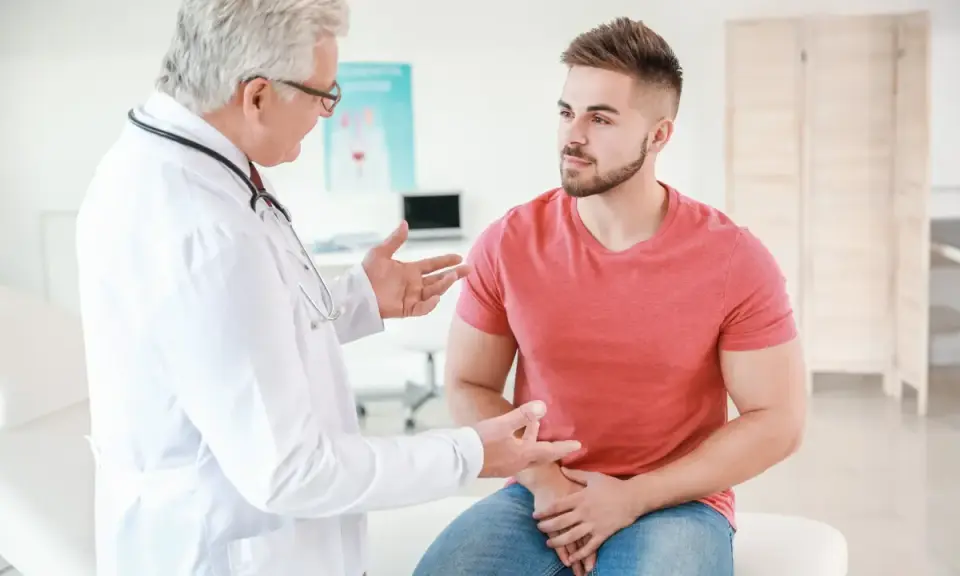 Lekarz omawia z pacjentem objawy, które mogą wskazywać na ostre zapalenie prostaty.