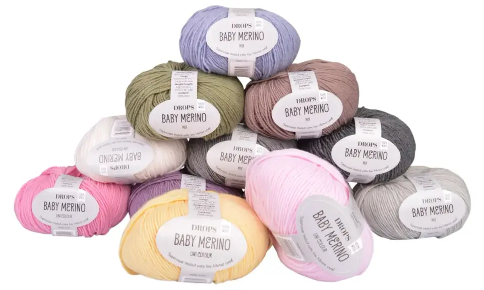 Här är ett urval av DROPS Baby Merino-garn i olika färger, perfekt för att sticka en mjuk babyfilt.