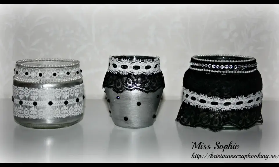 Three decorated glass jars with lace and beads.