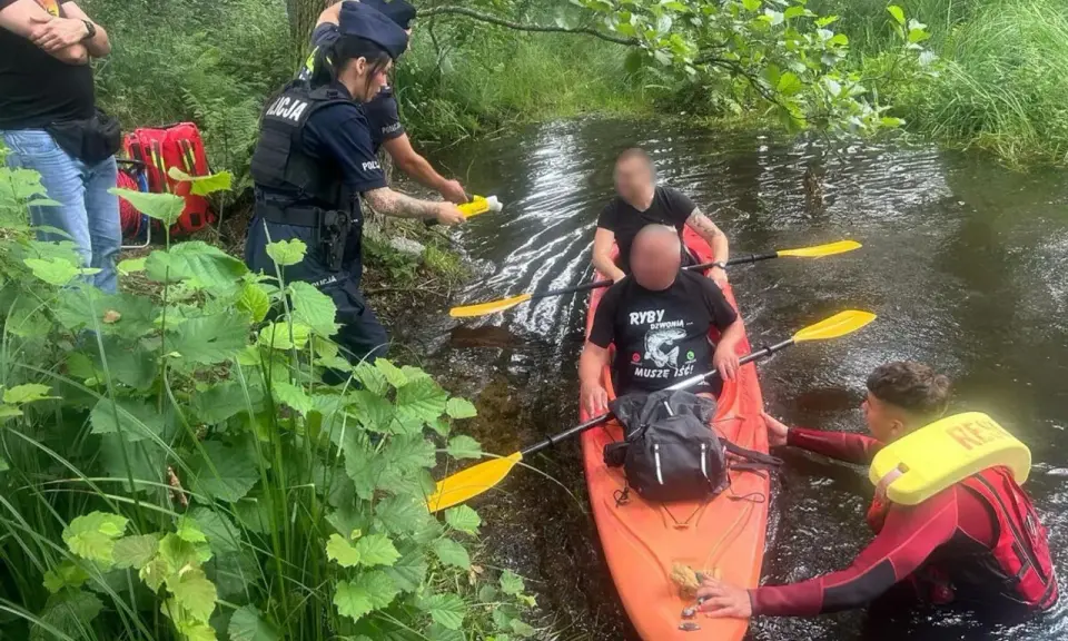 Policja przeprowadza rutynową kontrolę trzeźwości kajakarzy na rzece. Jeden z funkcjonariuszy używa alkomatu.