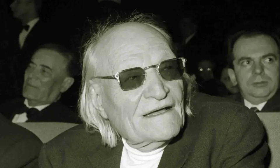 Un uomo anziano con occhiali da sole, capelli lunghi e bianchi, sembra un poeta. Sono una creatura ungaretti.