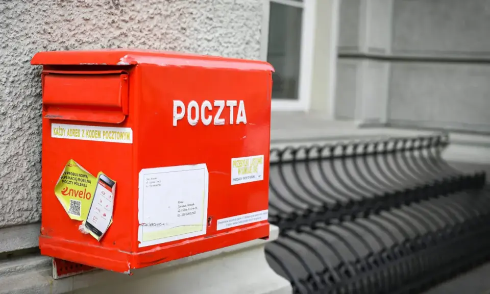 Czerwona skrzynka pocztowa z napisem "POCZTA". Można tu wysłać paczkę za granicę, listy i inne przesyłki.