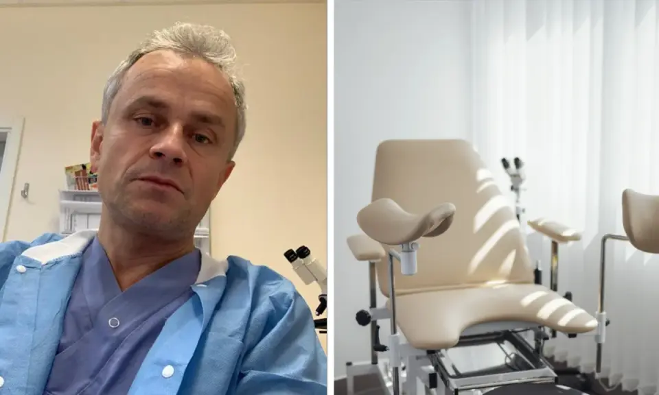 Manlig gynekolog i blå skyddsrock framför gynekologstol.