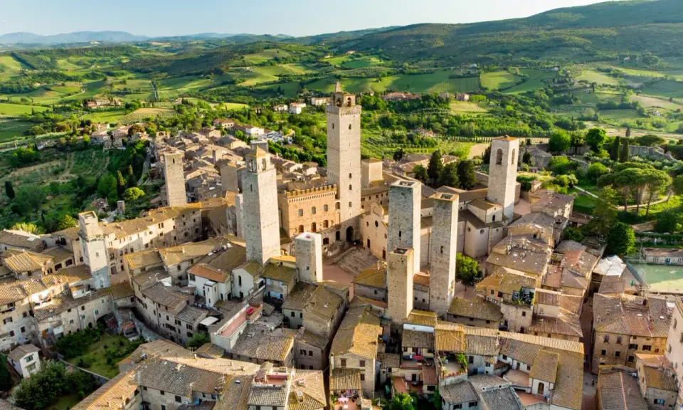 Aerial view of San Gimignano, Italy, with its medieval towers and Tuscan countryside.