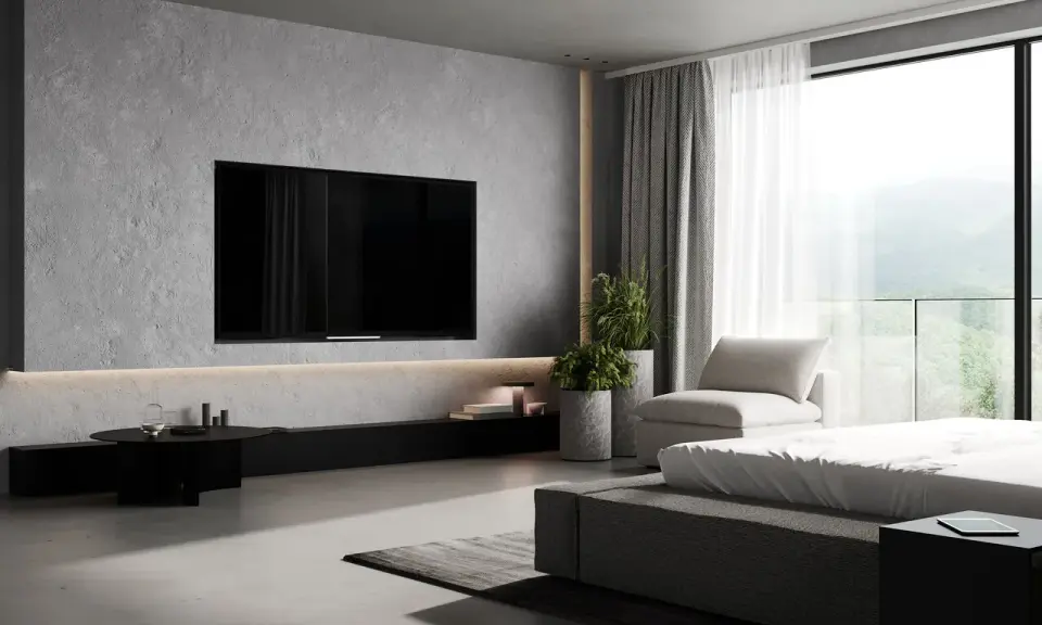Elegancka ściana z telewizorem w minimalistycznym wnętrzu. Betonowa faktura, dyskretne oświetlenie i widok na góry.
