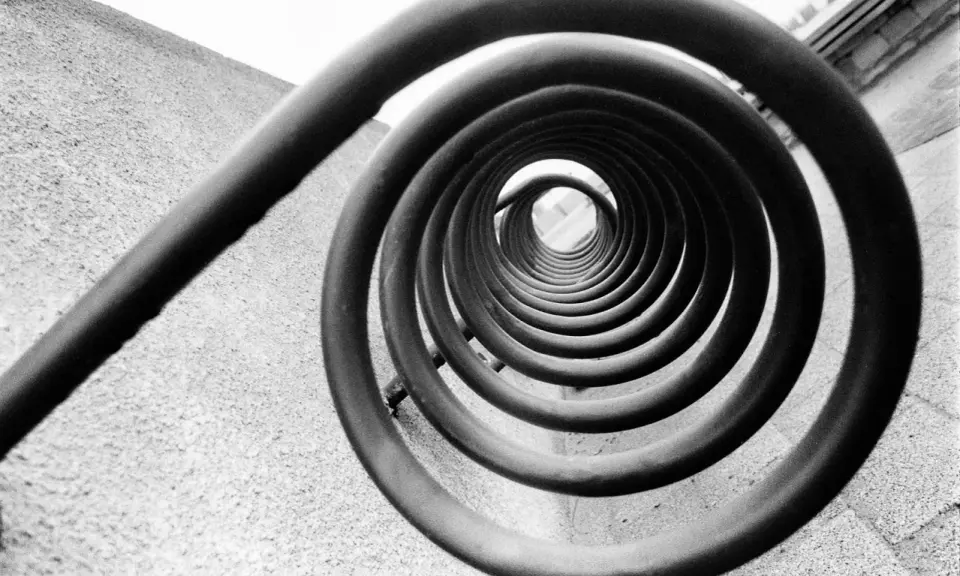 A spiral staircase, reminiscent of Edward Weston's famous photos, draws the eye inward.