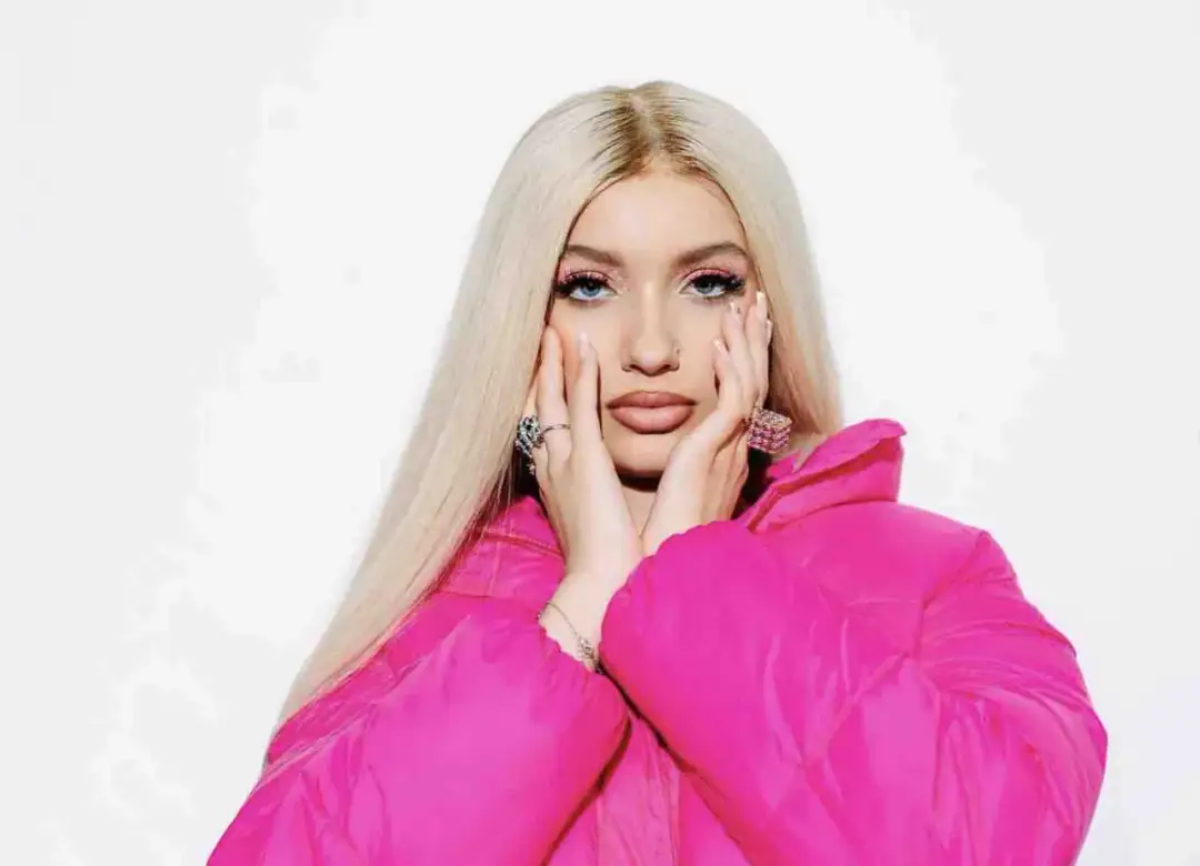Młoda kobieta z blond włosami i makijażem, w różowej kurtce. Wpisując "wiki gabor wiek" dowiesz się, ile ma lat.