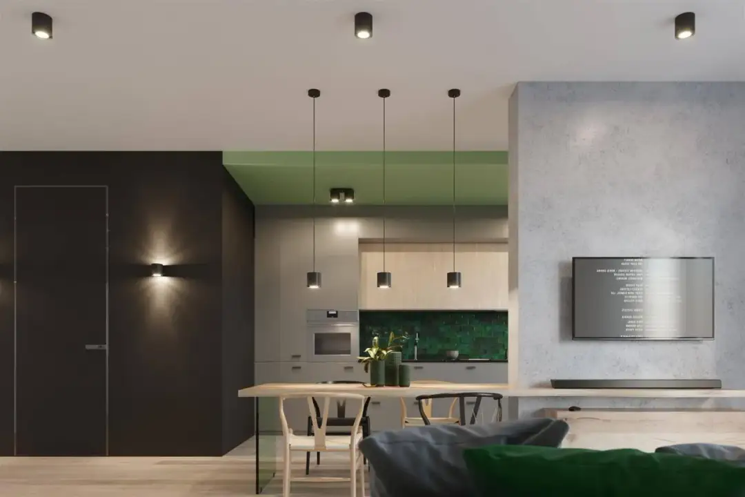 Nowoczesna kuchnia z wyspą i stołem, oświetlona kilkoma lampami sufitowymi tuba.