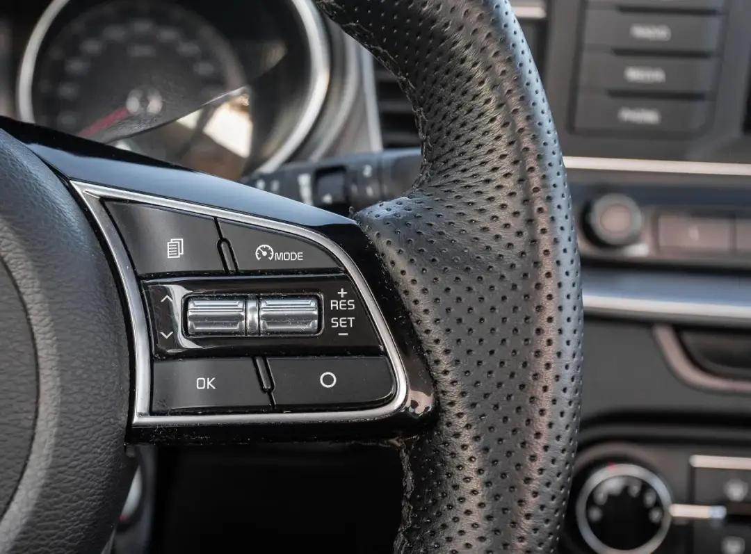 Kierownica z perforowanej skóry, przyciski sterowania tempomatem. Zastanawiasz się, ile kosztuje obszycie kierownicy?