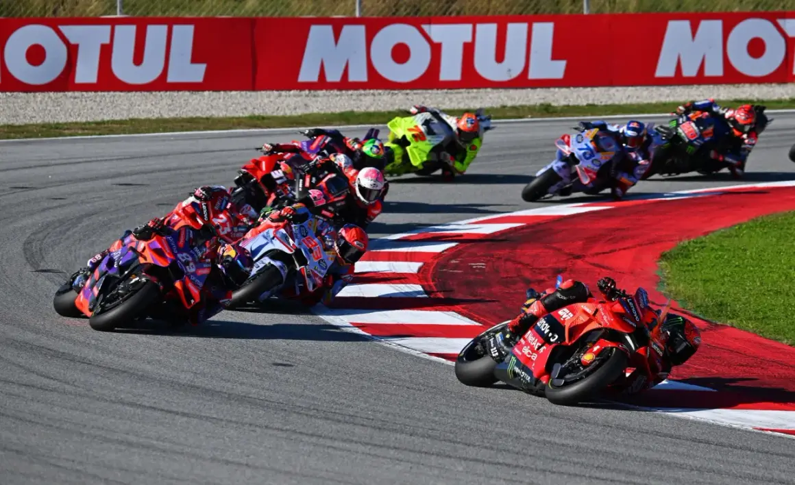 Carreras de MotoGP en curva, pilotos luchando por posición. El calendario MotoGP se llena de adrenalina.