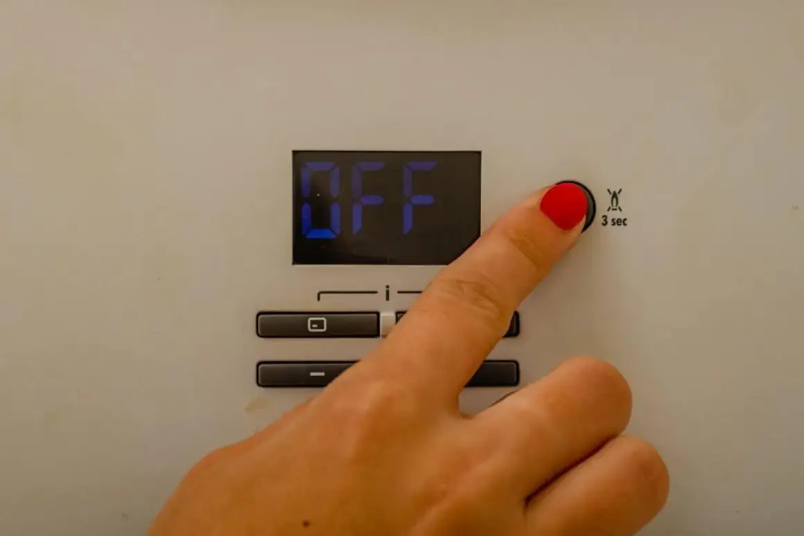 Dito che preme il pulsante per il reset caldaia Immergas. Lo schermo mostra "OFF".
