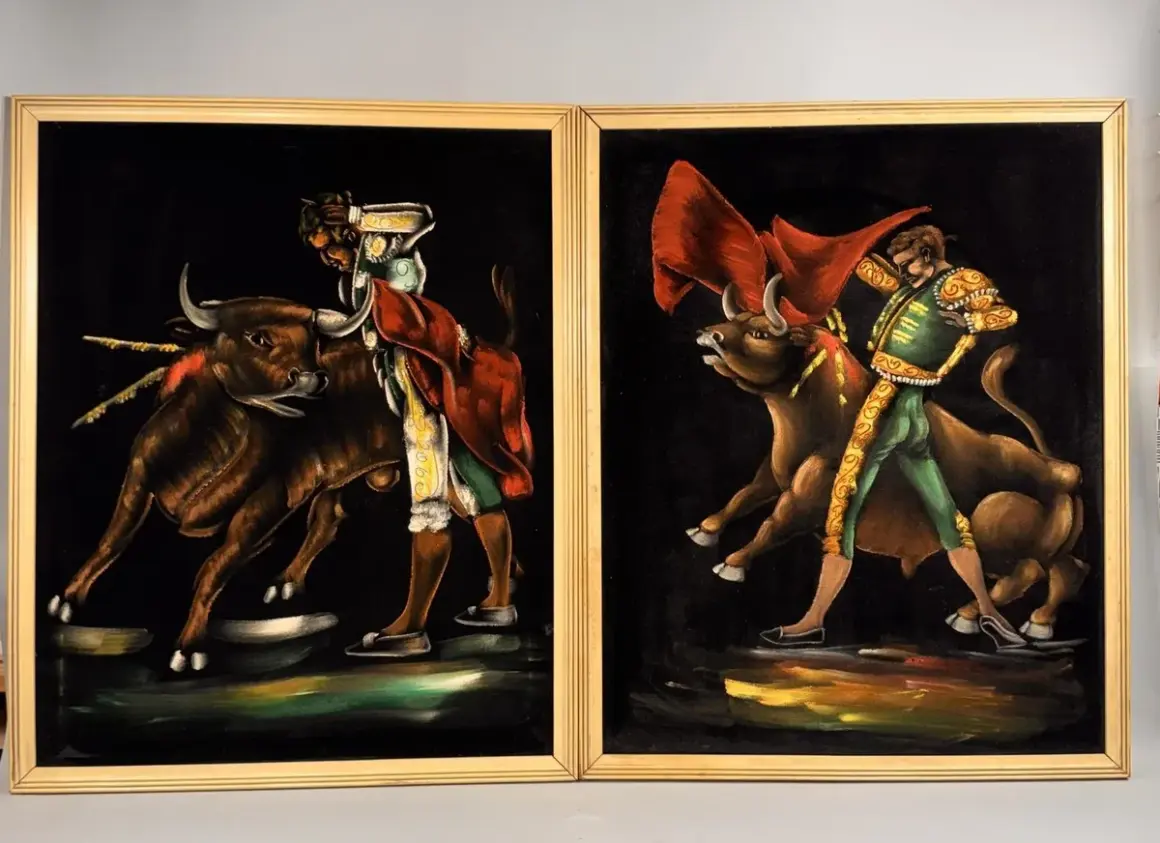 Two paintings by 1970s artists painters depict matadors facing bulls. The vibrant velvet art captures the drama of the bullfight.