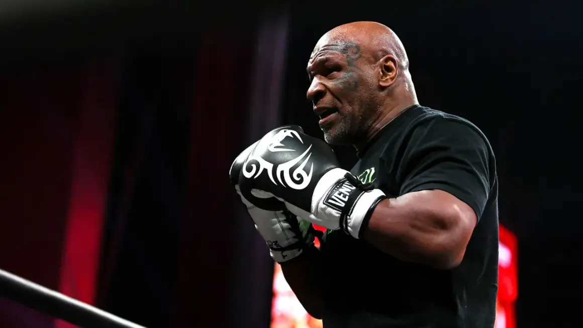 Mike Tyson, a symbol of raw power, shows his enduring strength in boxing gloves.