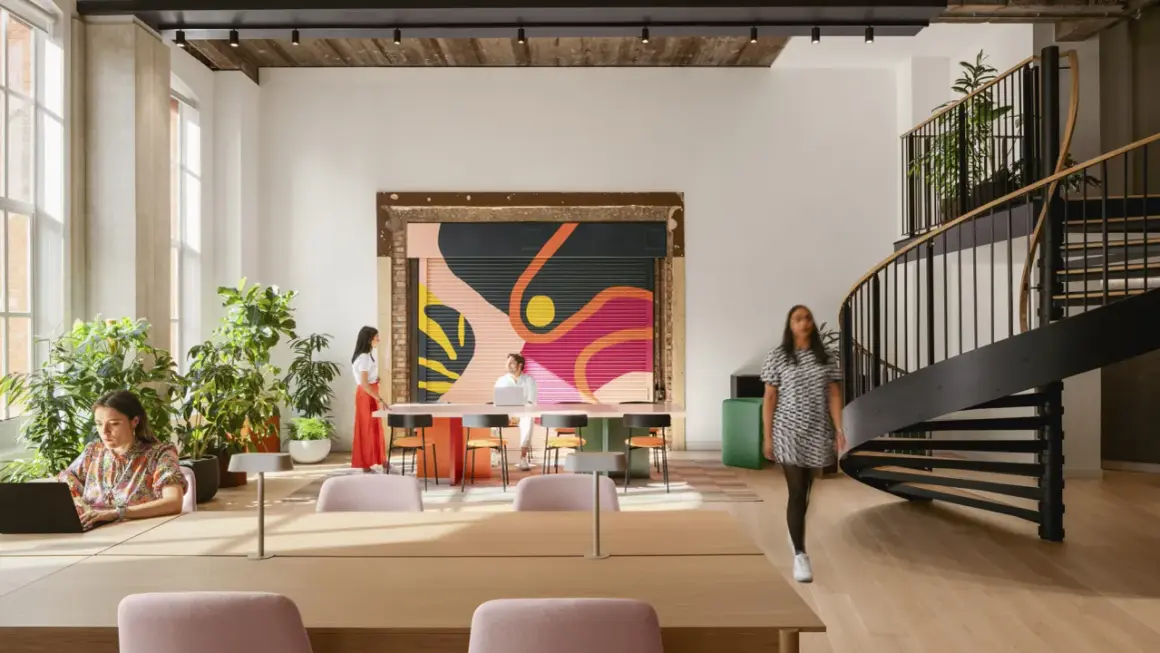 Vibrant mural and spiral staircase showcase current design trends in this modern workspace.