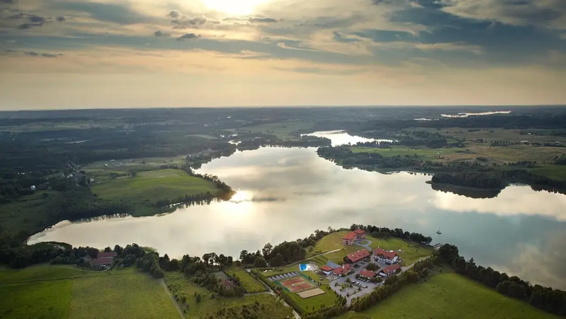 Malownicze jezioro na Mazurach z kompleksem wypoczynkowym i kortami tenisowymi. Idealne miejsce na nietypowe atrakcje Mazury.