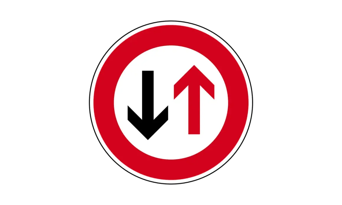 Verkehrsschild: Vorfahrt für den Gegenverkehr. Ein roter Kreis mit weißem Grund zeigt einen schwarzen Pfeil nach unten und einen roten Pfeil nach oben.