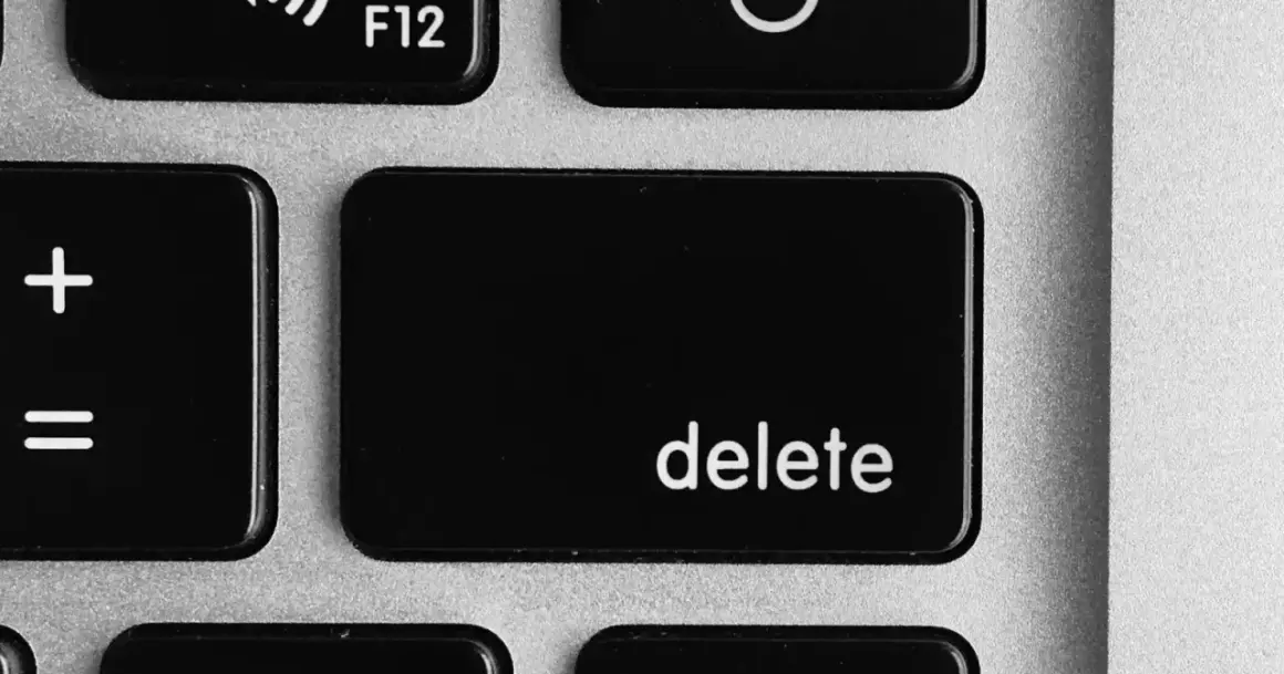 Close-up of a laptop keyboard showing the '+' and '=' keys, and the prominent 'delete' key.