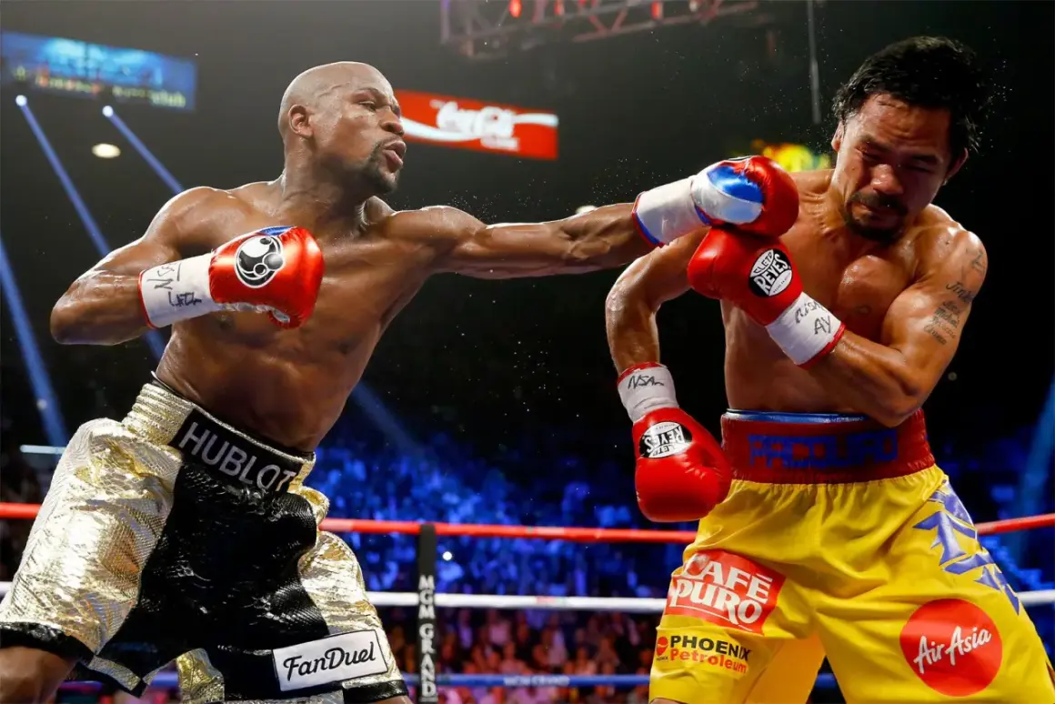 Two boxers in a ring, one throwing a punch. The inside fighter, with gold shorts, connects with his opponent.