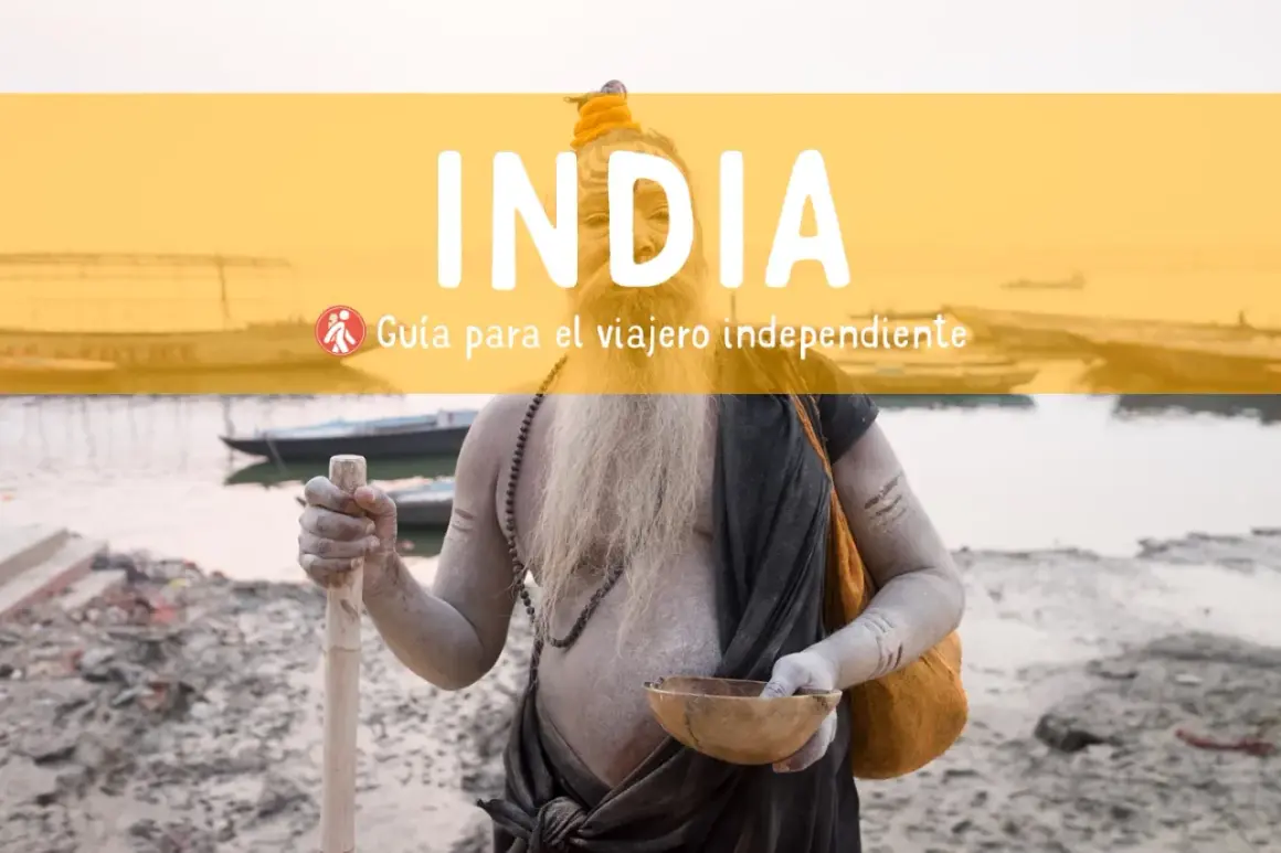 Un sadhu con barba y cuerpo cubierto de ceniza sostiene un bastón y un cuenco. Texto: "INDIA. Guía para el viajero independiente". Consejos para viajar a la India.