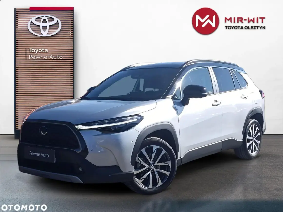 Srebrny Toyota Corolla Cross na jazdach testowych przed salonem Mir-Wit Toyota Olsztyn.