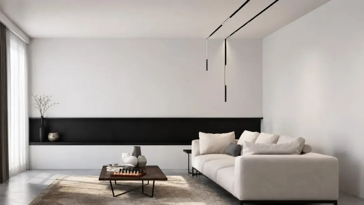 Nowoczesne oświetlenie do salonu aranżacje: minimalistyczny salon z beżową sofą, czarną półką i designerskimi lampami wiszącymi.