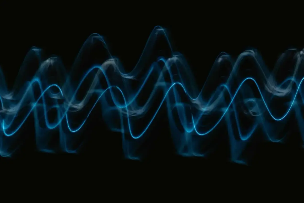 Abstract blue light trails form wave patterns on a black background, visualizing the sound waves that play wav files.