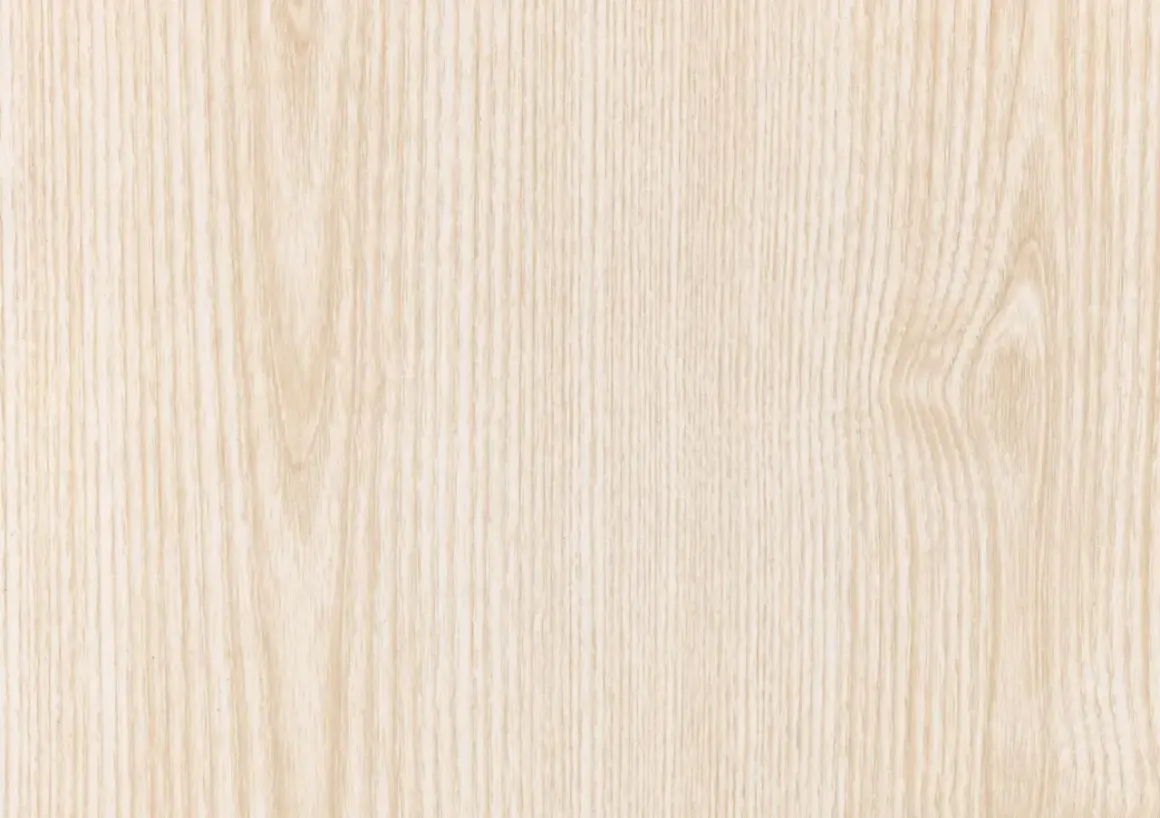 Texture naturelle de couleur bois frêne, aux veines fines et claires, évoquant la douceur et la pureté.