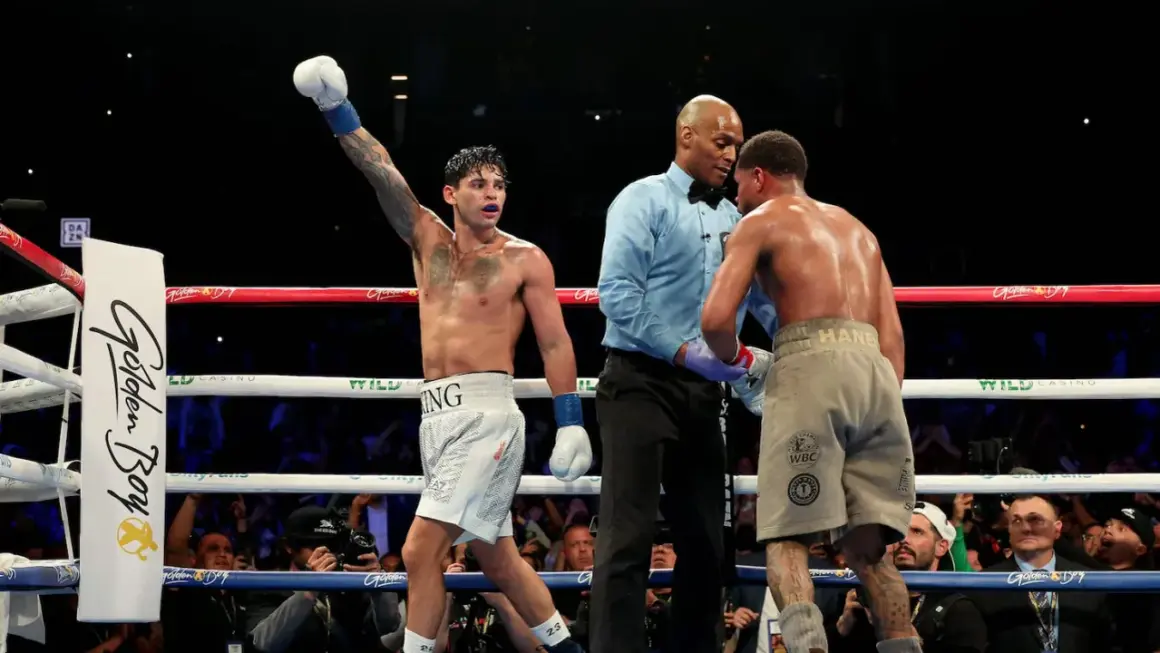 Boxer with arm raised, referee between two fighters. A majority decision in boxing means two of the three judges scored the fight for one boxer.