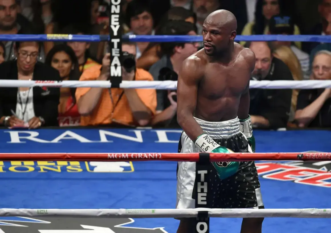Floyd Mayweather Jr. in the ring, a testament to how long has Floyd Mayweather been boxing. His focused gaze hints at years of dedication.