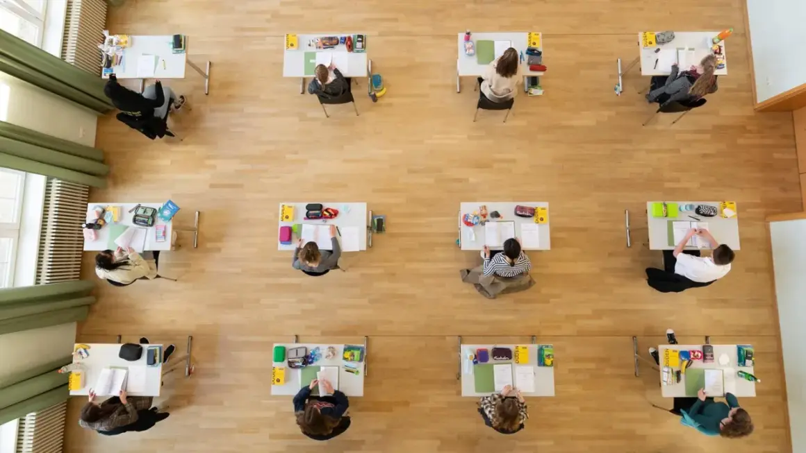 Schülerinnen und Schüler konzentriert bei Prüfungen, die an die Abiturtermine Niedersachsen 2026 erinnern.