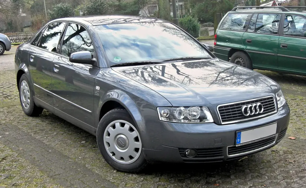 Szary sedan Audi A4 B6 zaparkowany na zewnątrz.