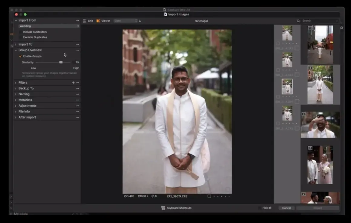 Mężczyzna w białej szacie ślubnej uśmiecha się do kamery. Capture One pozwala na import i grupowanie zdjęć.