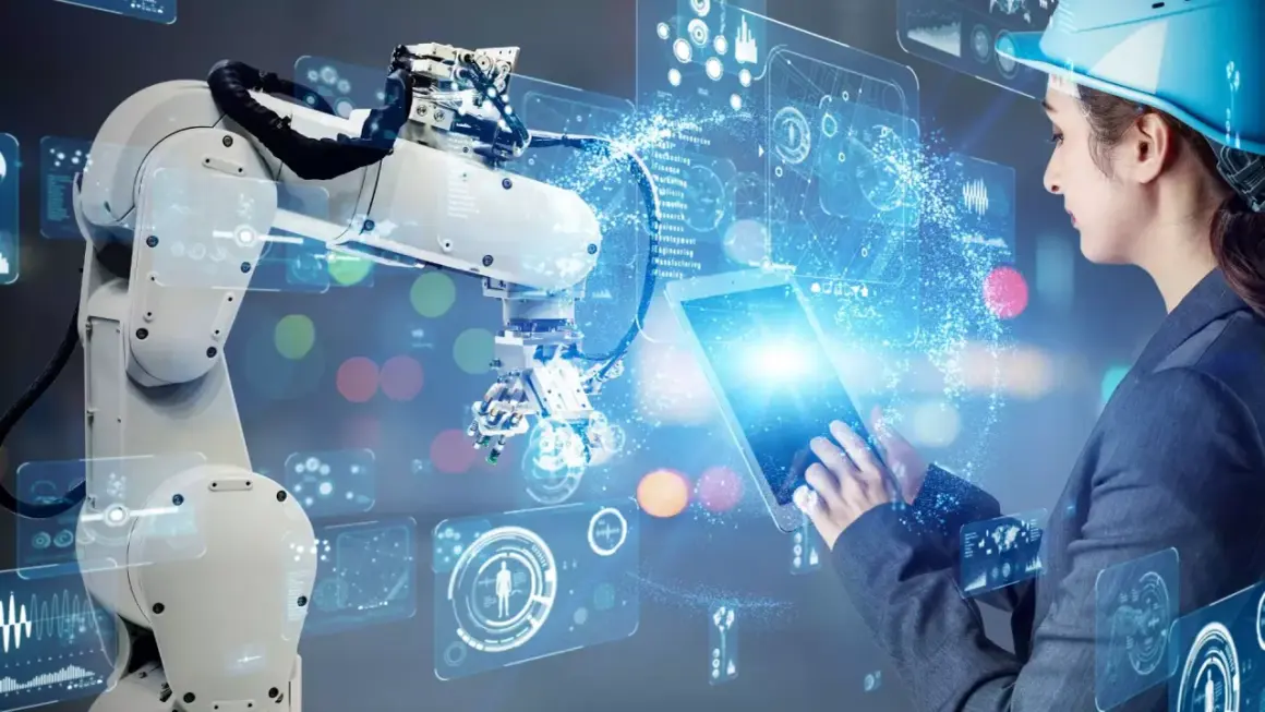 Inżynierka steruje robotem przemysłowym za pomocą tabletu, wizualizując dane w technologii **przemysł 5.0**.