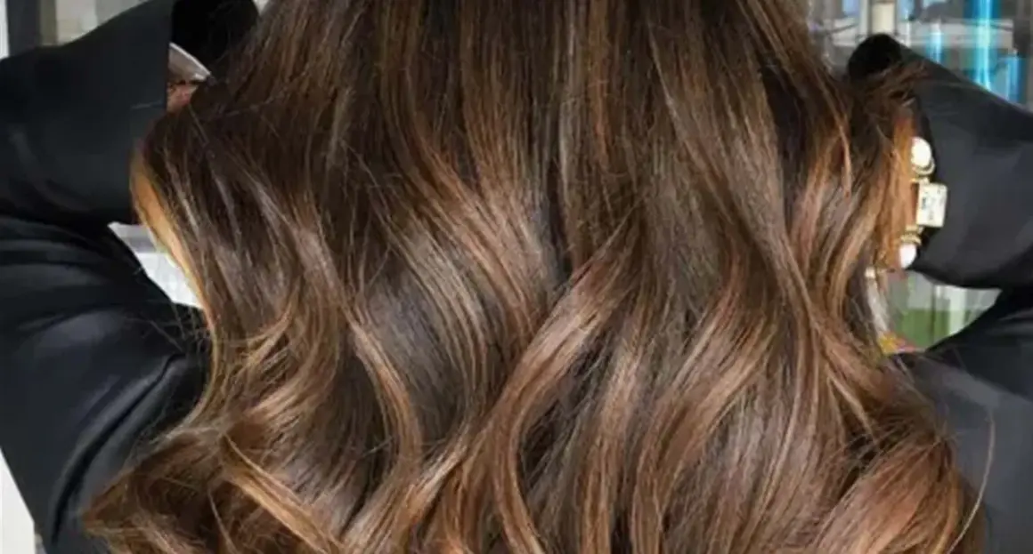 Glänzendes, glattes Haar mit Balayage in Braun-Caramel-Tönen, das wie flüssiges Gold fällt.
