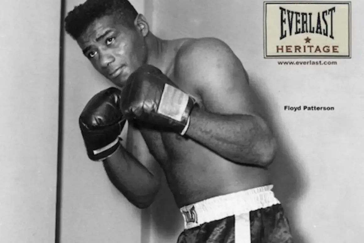 Floyd Patterson, a legendary boxer, poses in the ring, his record etched in boxing history.