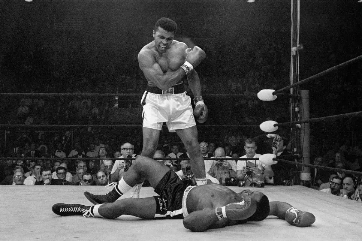 Muhammad Ali stands over a fallen opponent, embodying his famous quote to float like a butterfly and sting like a bee.
