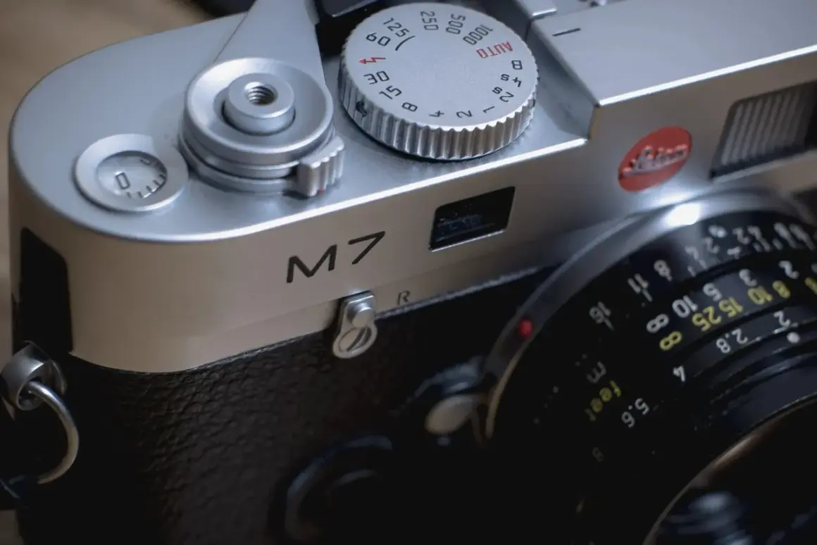 Close-up of a Leica M7 camera, ready for a detailed review. The silver body gleams, showing the "M7" inscription and lens details.