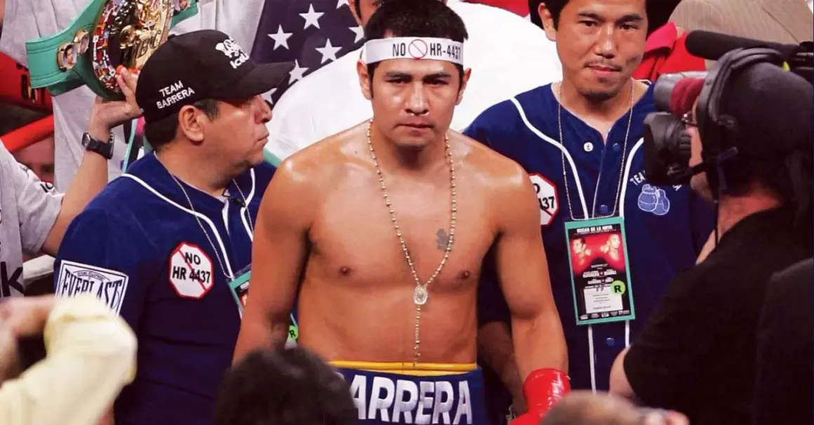 Marco Antonio Boxer, the champion, stands ready, a championship belt held high by his team.
