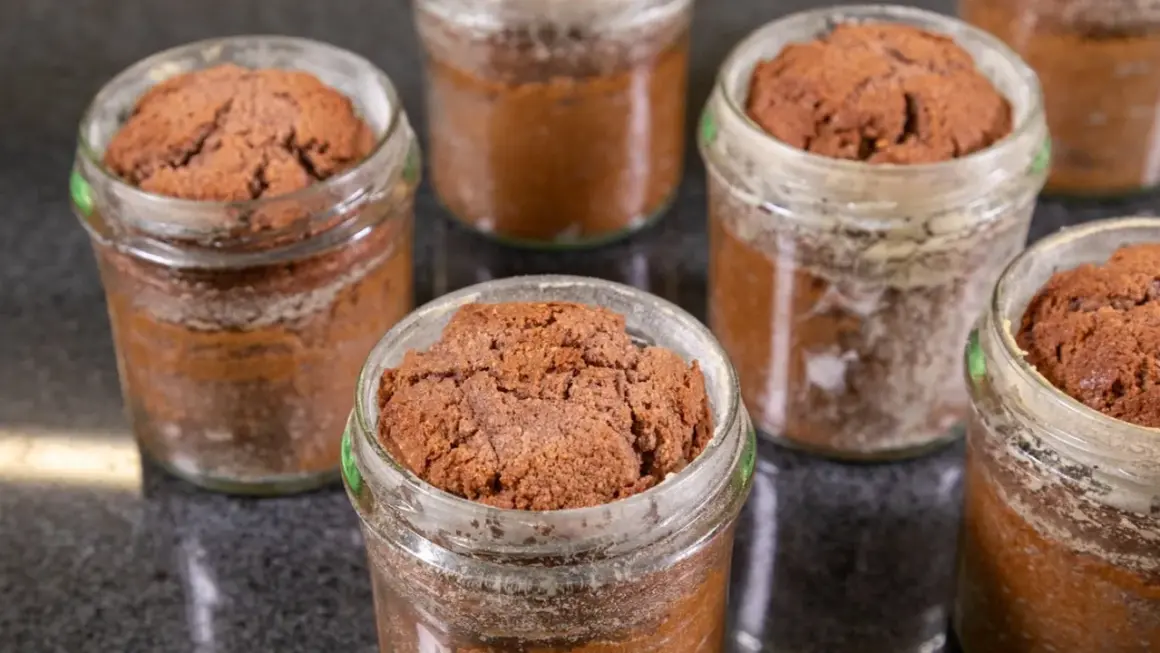 Mehrere kleine Schokoladenkuchen im Glas, bereit zum Genießen.