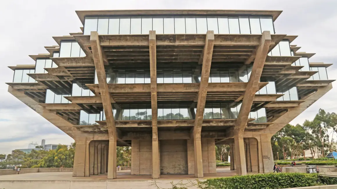 The Geisel Library, a famous brutalist architecture masterpiece, features stacked concrete levels with glass windows, resembling a Mayan pyramid.
