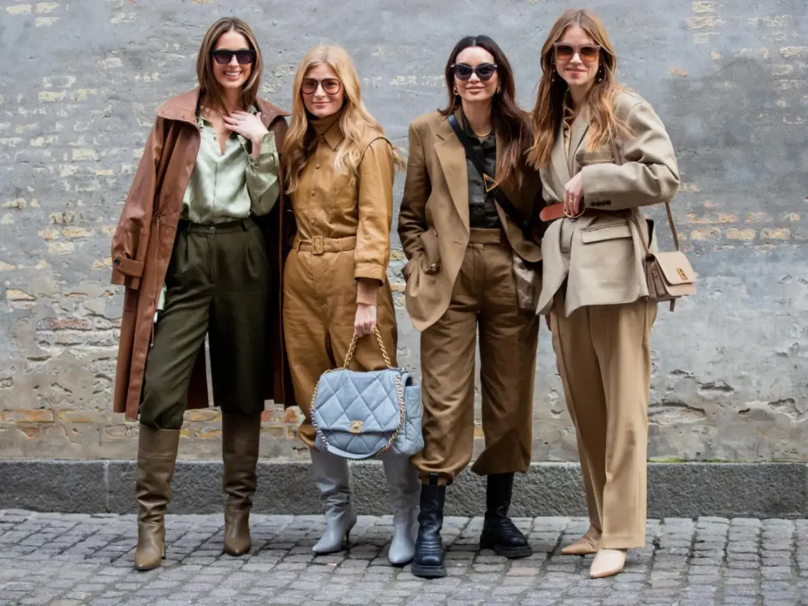 Vier Frauen in erdigen Tönen zeigen, was man bei 10 Grad anzieht: Leder-Trenchcoat, Anzüge und Stiefel.