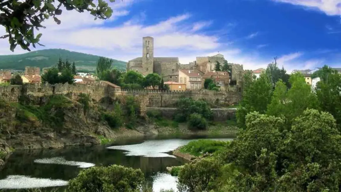 Pueblo amurallado con río y vegetación exuberante. ¡Ideal para saber qué hacer hoy en la sierra de Madrid!