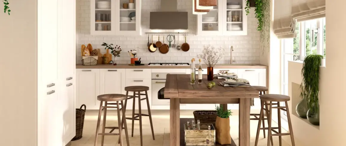 Cucina luminosa con pavimento in cotto, mobili bianchi, isola in legno e dettagli rustici. Perfetti abbinamenti cucine con pavimento in cotto per un ambiente caldo.