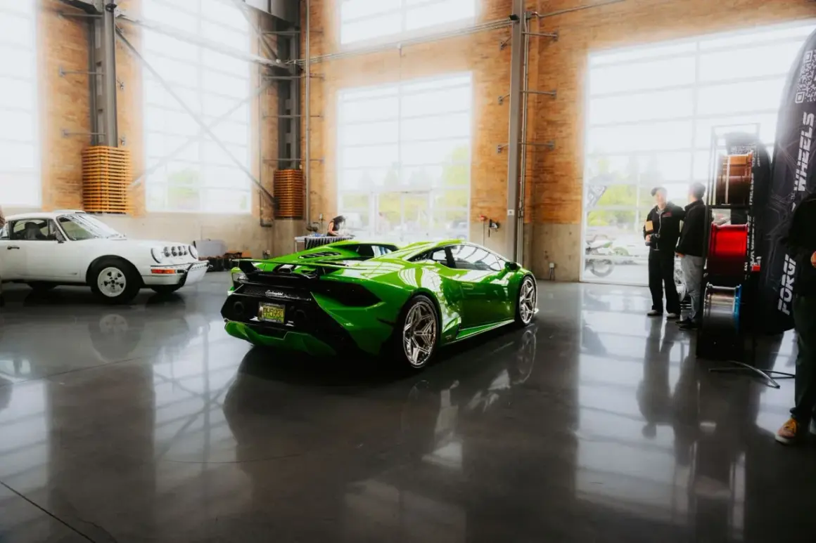 Une Lamborghini verte et une Porsche blanche dans un showroom. Le rachat LOA par concessionnaire est une option pour acquérir ces merveilles.