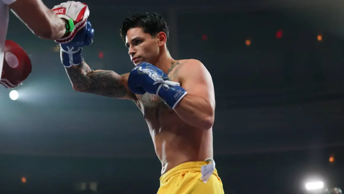 Ryan Garcia trains with a punching bag, his blue gloves a blur of motion.
