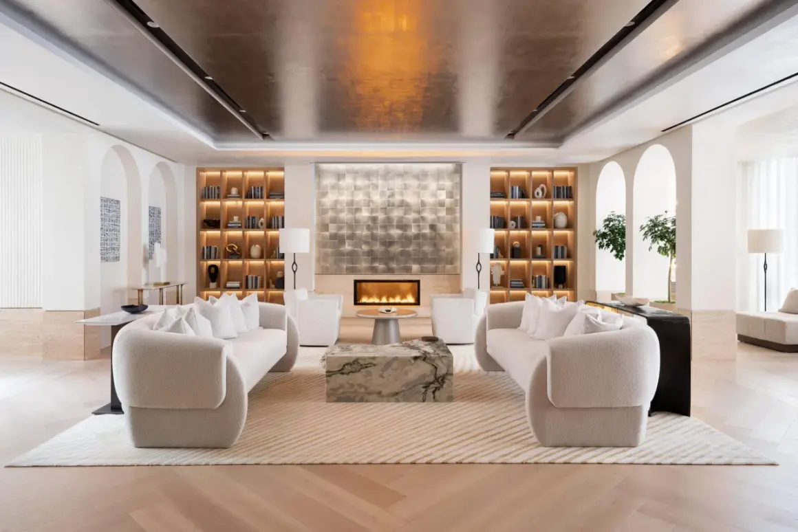 A luxurious living room designed by top interior designers, featuring plush sofas, a modern fireplace, and elegant built-in shelving.