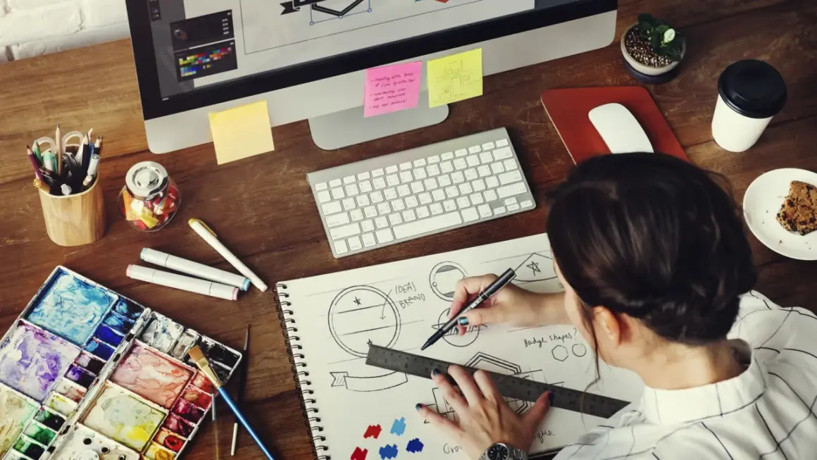 A graphic designer sketches logo ideas, a key step in learning how to make money as a graphic designer.