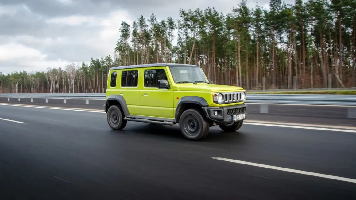 Jaskrawozielony suzuki jimny 5-drzwiowy na drodze. Sprawdź suzuki jimny 5-drzwiowy cena i możliwości.