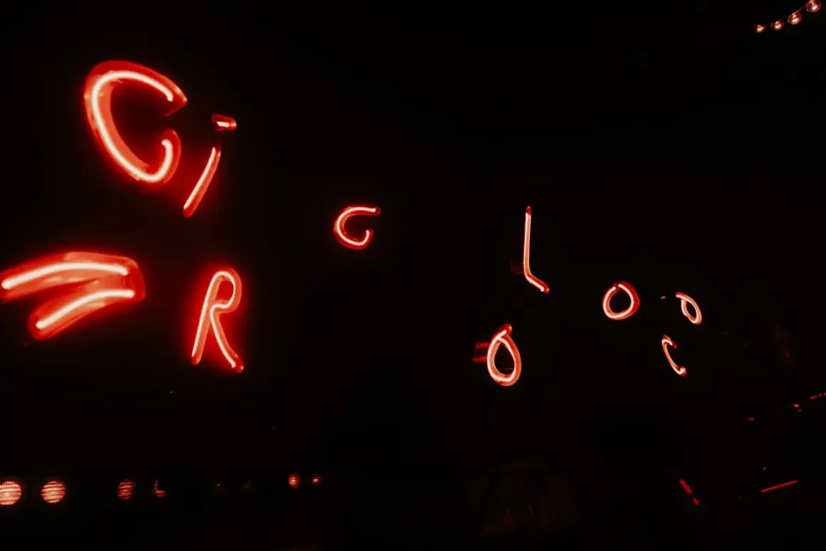 Luci al neon rosse formano le lettere "CIRCOLOCO", un invito a scoprire cos'è questo luogo magico.